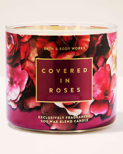 Bath & Body Works candle with floral design and 'Covered in Roses' text.