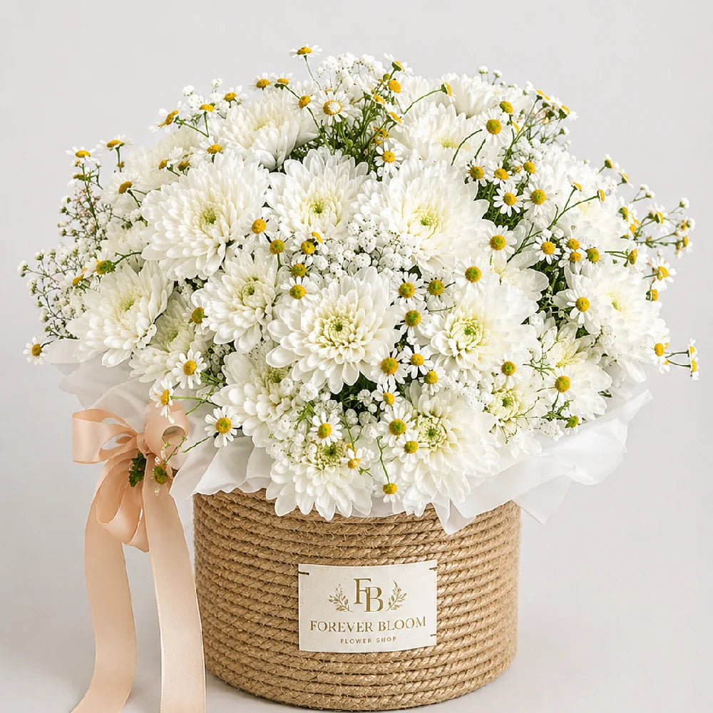 Bouquet of white flowers in a woven basket with 'Forever Bloom' label on a light background