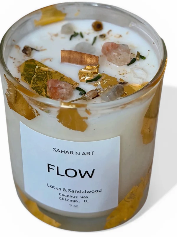 Candle with decorative elements and 'Sahar N Art' label on a white background