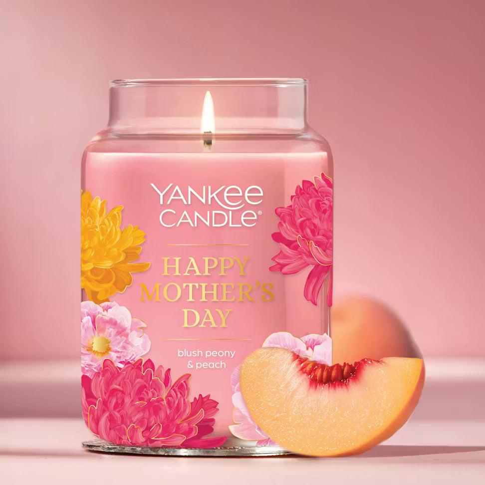 Yankee Candle Mother's Day candle with floral design and peach slice on pink background