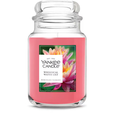 Yankee Candle Whimsical Water Lily candle with pink wax and floral label on a white background