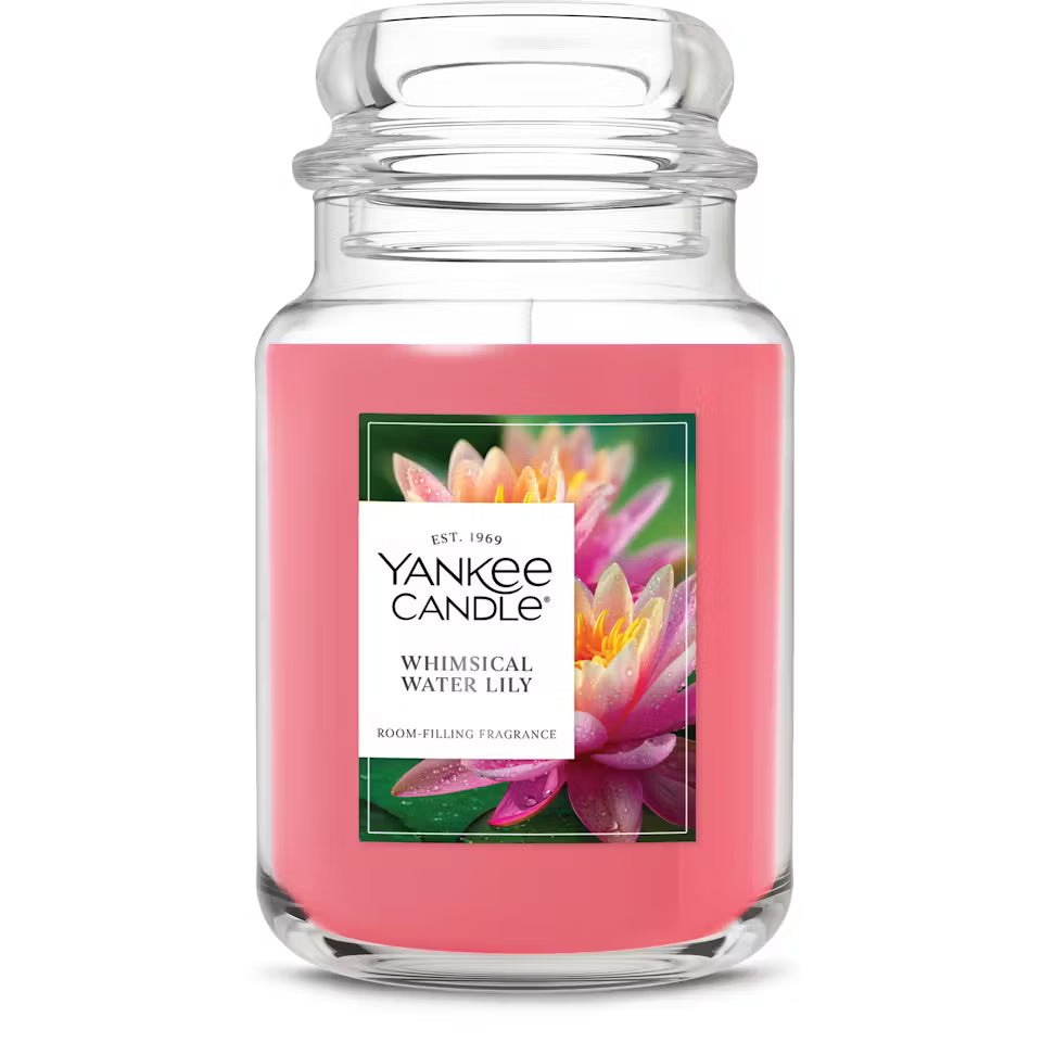 Yankee Candle Whimsical Water Lily candle with pink wax and floral label on a white background